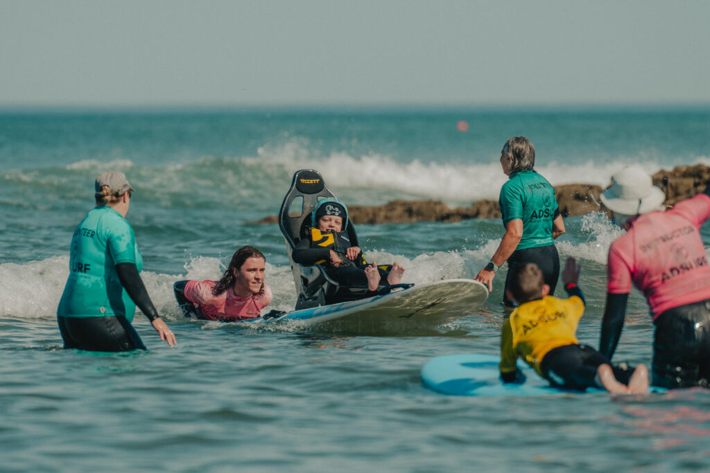 A group of people in the surf with surboards