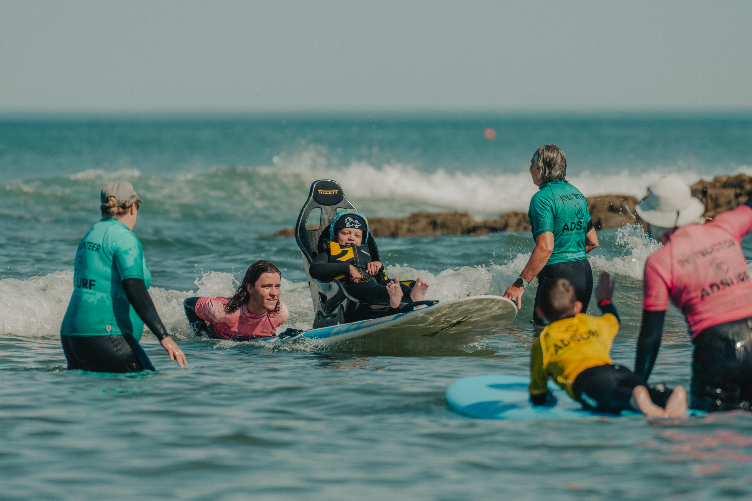 A group of people in the surf with surboards