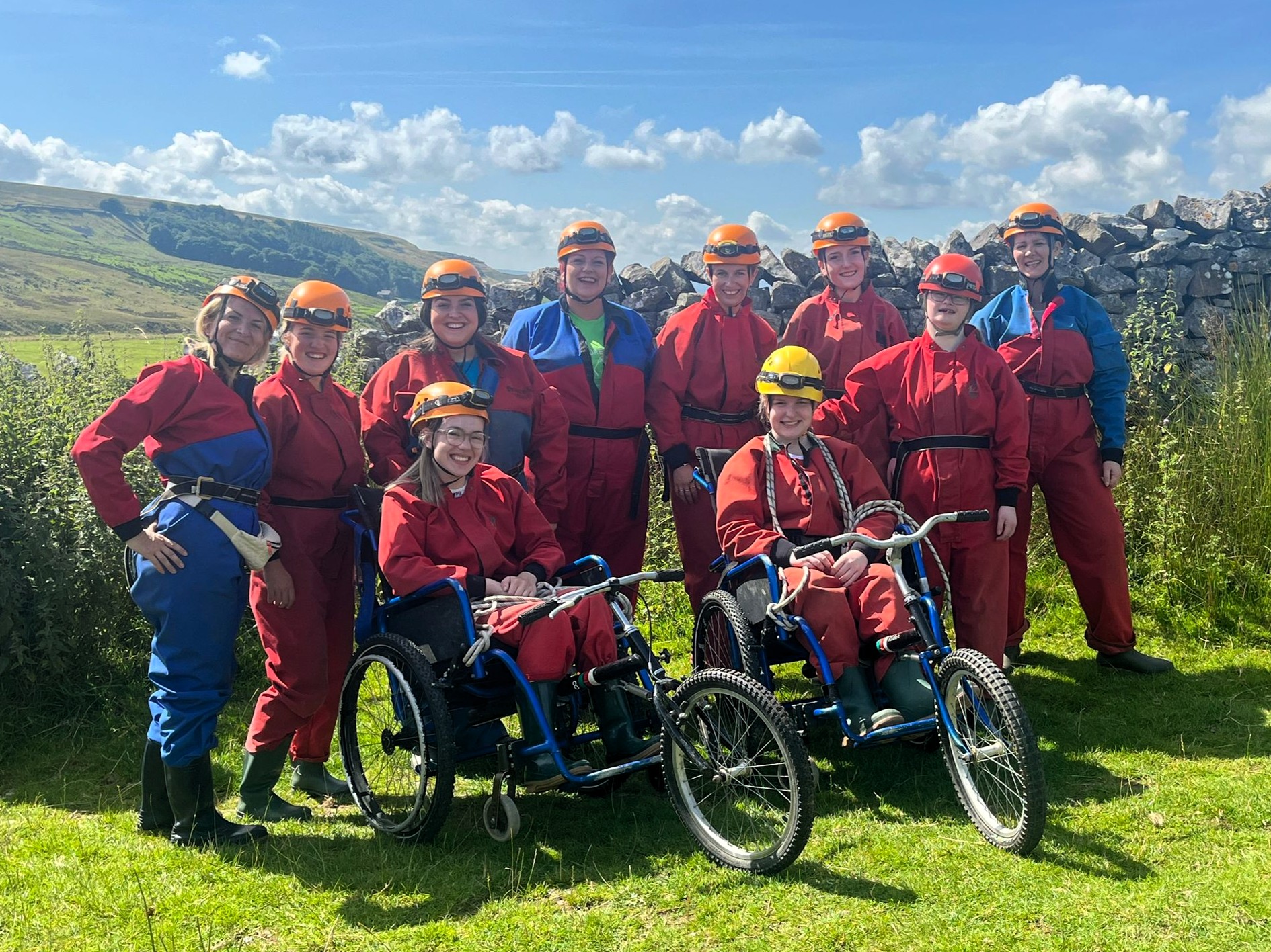 A group of people on a Phab adventure stand in a field