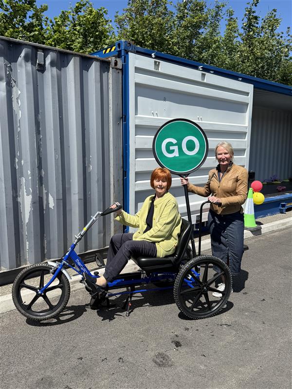 Two women, a trike and a stop sign