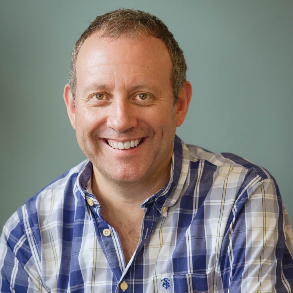 Portrait photo of a man with a checked shirt