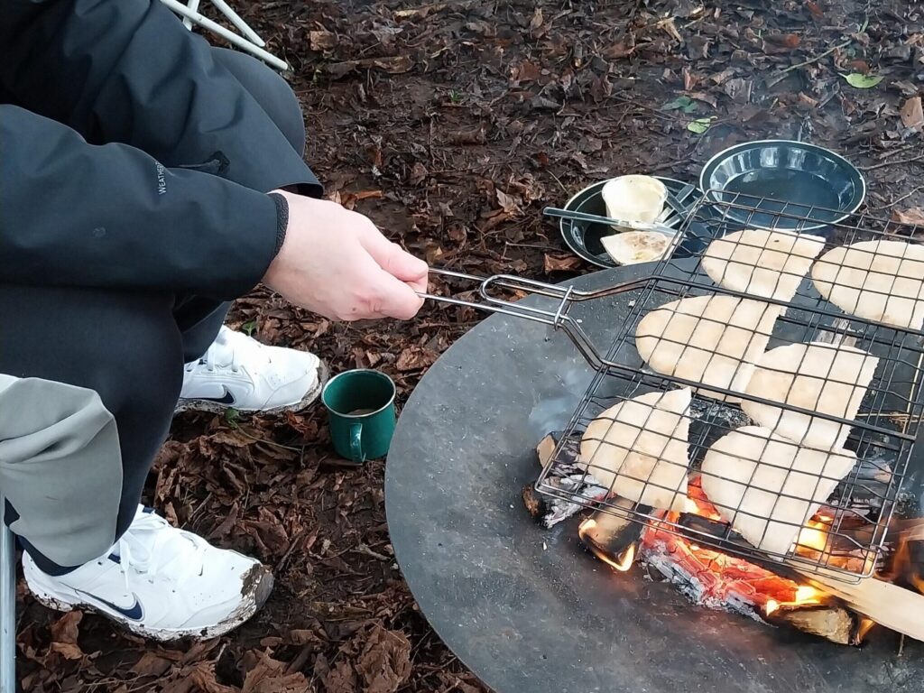 pita and feta being toasted over a fire