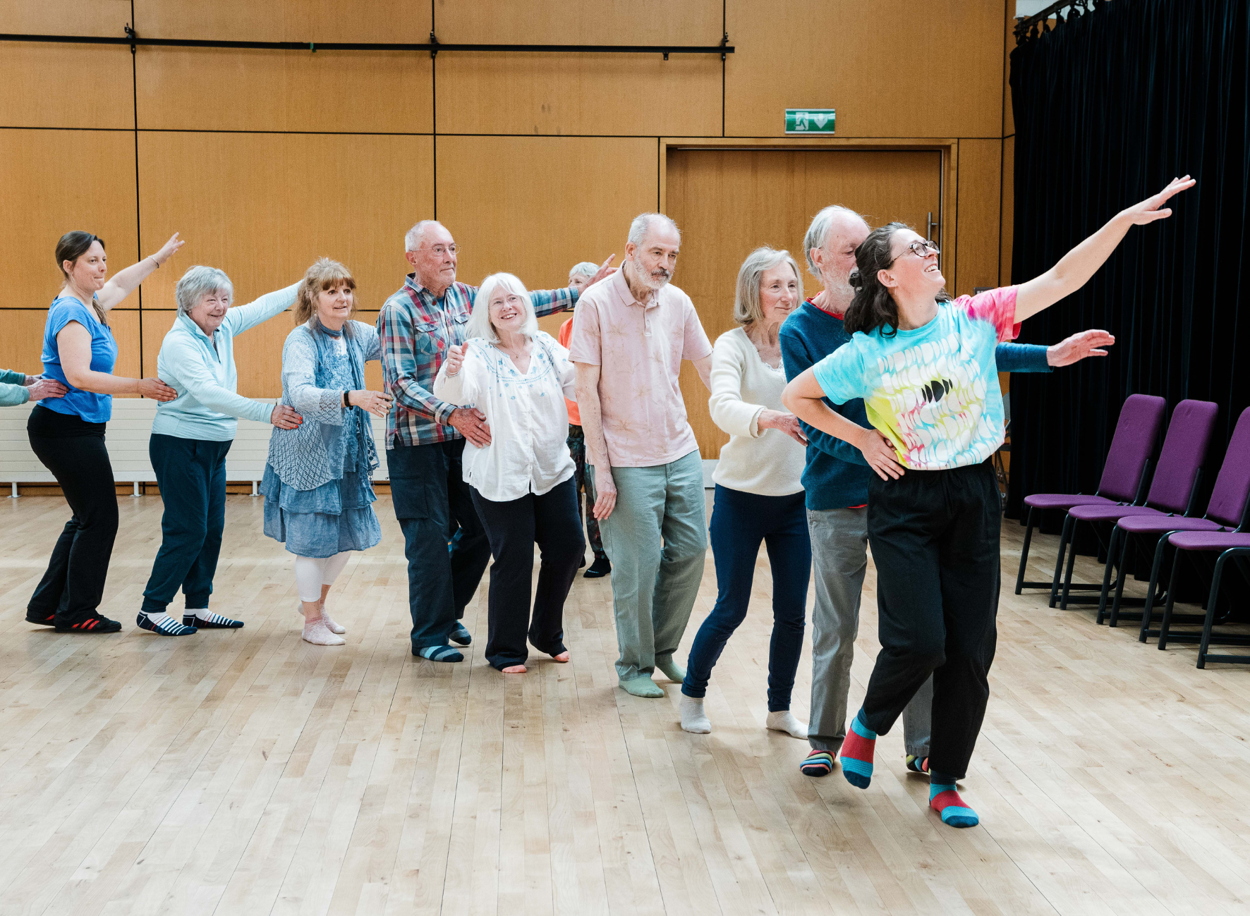 A line of people dancing in a hall