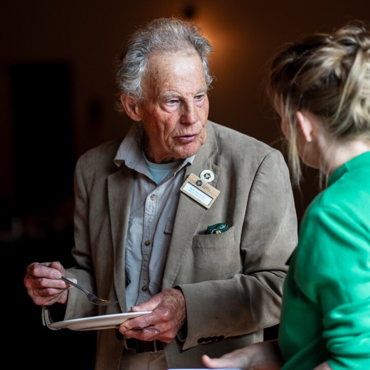 A man in a jacket at a conference